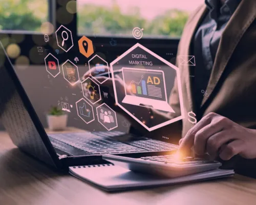 Marketer working on a laptop with digital marketing icons overlaid, representing how a digital storyboard creator helps visualize ad sequences, brand messaging, and storytelling in advertising and marketing campaigns.