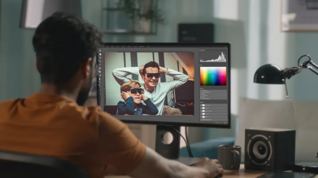 Man editing video on a computer with color grading and histogram tools, representing post-production budget items such as editing, VFX, sound design, color correction, and music licensing in a film budget template.