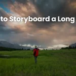 Person in red jacket standing in a wide open field with dramatic sky and distant mountains, representing a cinematic long shot for storyboard planning