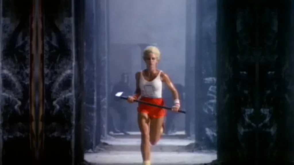 Scene from Apple’s “1984” commercial showing a woman in red shorts running with a hammer, exemplifying early use of storyboard-driven brand storytelling in advertising.